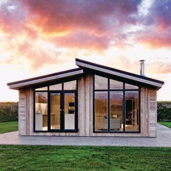 Lake District Honeymoon Accommodation. Image of North Lakes Lodges Lodge from the front with a colourful sky.